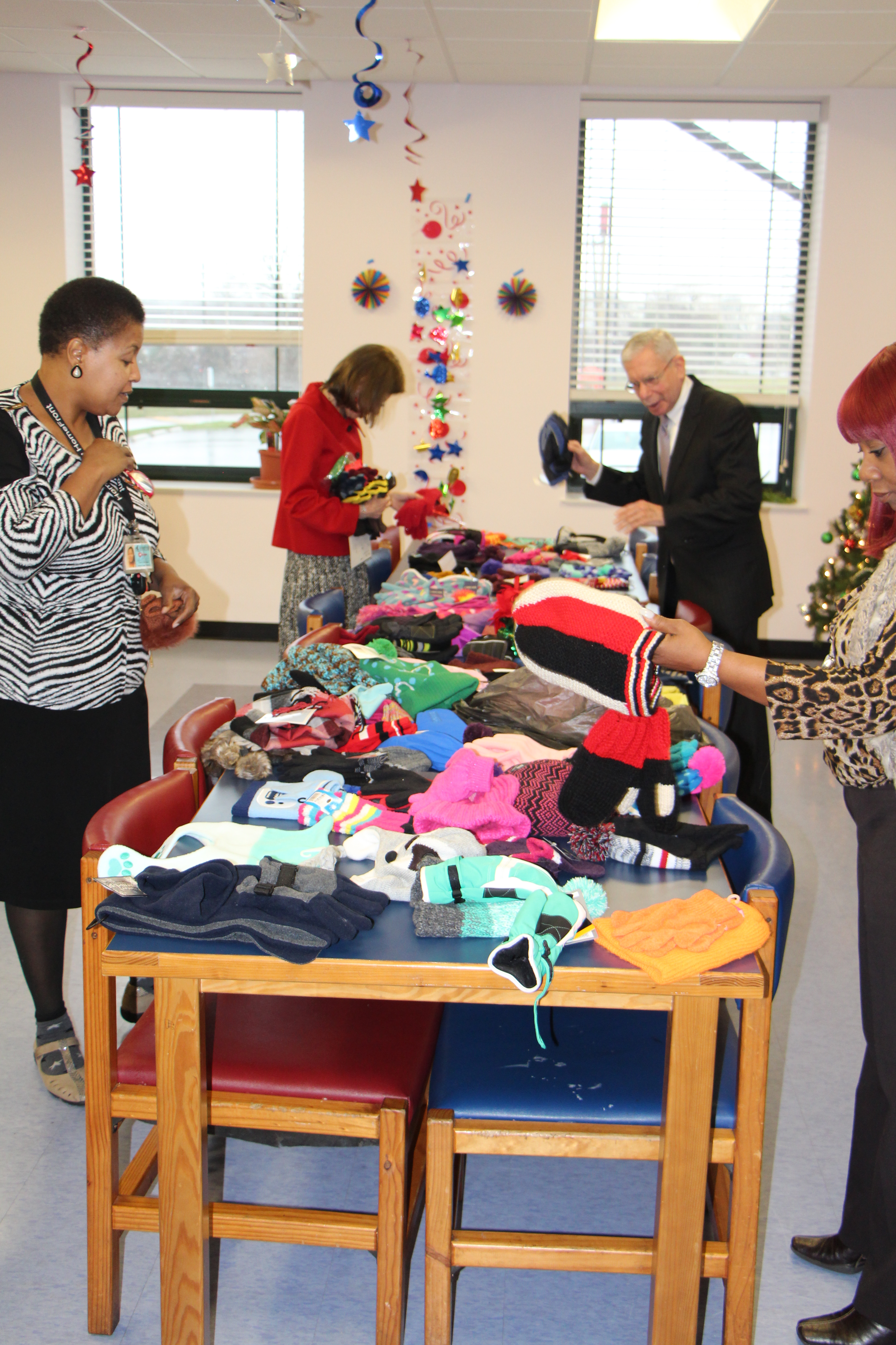 People checking on donated clothing laying on the tables.