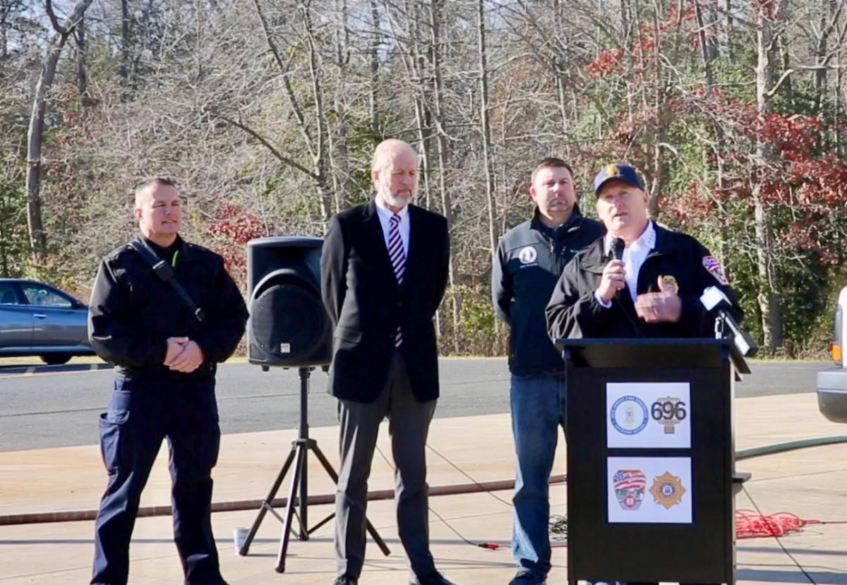 State Fire Marshal Richard Mikutsky addresses the crowd at a live side-by-side Christmas tree burn demonstration at the Monmouth County Fire Academy to demonstrate the importance of fire safety, especially during the holidays. DCA / Elizabeth Lara-Collado 