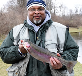 Angler with large rainbow trout