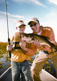 Father and son with bass