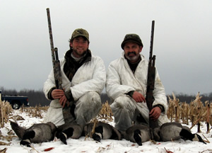 Hunters in field with Canada geese