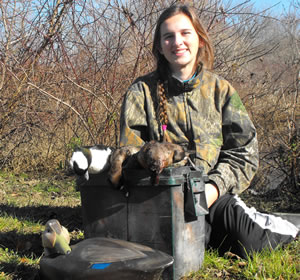 Hunter with harvested diving ducks