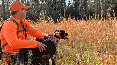 Hunter with Dog in Field