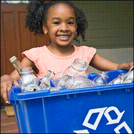 A child holding a recycling bin filled with recyclables. 