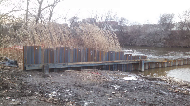 photo-Installation of coffer dam at mouth of kayak channel in Cooper River