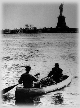 Canoe trip from Black Tom to the Statue of Liberty, with a view of the Statue of Liberty in the backdrop.  