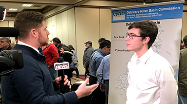 A reporter interviewing a man