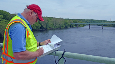 A worker taking notes on the bridge