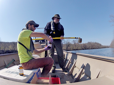 Staff collect a water sample from the Lehigh River to monitor for 1,4-Dioxane, a contaminant of emerging concern. Photo by DRBC.
