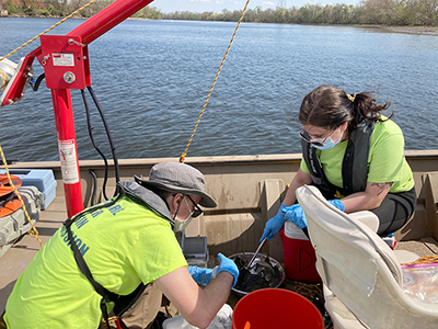 DRBC staff collects a sediment sample from the Delaware River Estuary to monitor for PFAS. Photo by DRBC.