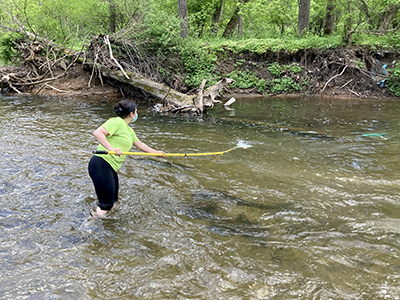 DRBC staff collects a water sample to monitor for chlorides from the Pohatcong Creek, a N.J. Delaware River tributary. Photo by DRBC.