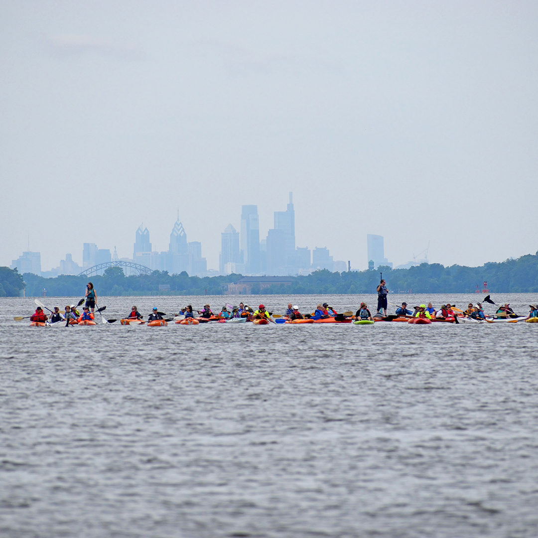 On Day 7, Sojourners paddle with the Philadelphia skyline in the background. Photo courtesy of Prem Trivedi, Riverways Collaboration.