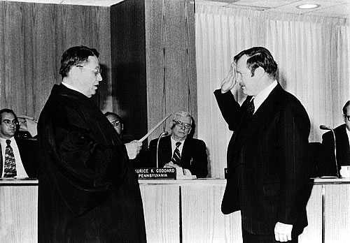 Gerald M. Hansler is shown here being sworn in as DRBC executive director by Associate Justice Lawrence H. Cooke of New York during DRBC’s October 1977 meeting in Monticello, N.Y. Hansler was hired after a national recruitment search.  His resume included seven years of service as a regional administrator for the U.S. Environmental Protection Agency. His directorship of EPA’s regional office responsible for New York and New Jersey was part of 22 years of prior experience which also included working throughout the nation on public health issues (many concerning water and pollution control) as a U.S. Public Health Service officer. For its first 15 years, DRBC was directed by James F. Wright, who retired in July 1977.