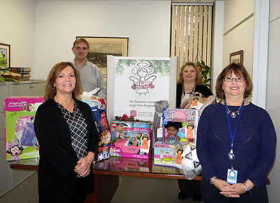 DRBC's Finance/Administration staff, who helped organize the gift drive, pose with the donated toys. Photo by DRBC.
