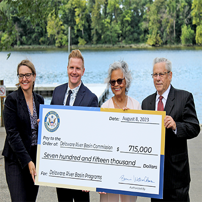 From L to R: DRBC's Deputy Exec. Dir. Kristen Bowman Kavanagh, NJDEP Commissioner Shawn LaTourette, U.S. Representative Bonnie Watson Coleman and Ewing Twp. Mayor Bert H. Steinmann hold a check for $715,000 in Community Project Funding for the DRBC. Photo by the DRBC.