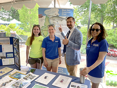 The DRBC's Bailey Adams (far L), Elizabeth Brown (2ndfrom L) and Stacey Mulholland (R) pose with EPA Region3 Administrator Adam Ortiz at the DRBC's informationtable at World Environment Day. Photo by the DRBC.
