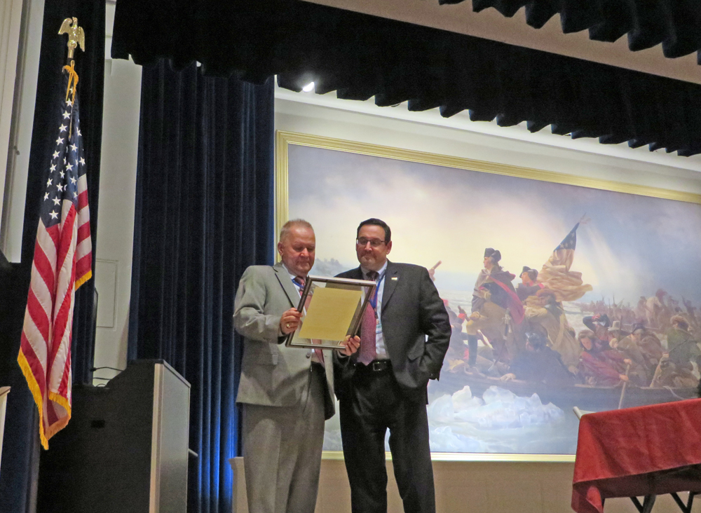 At its Mar. 15 business mtg, DRBC Exec. Dir. Steve Tambini (R) presents DRBC Dir. Finance & Admin. Rich Gore (L) with a special resolution for his retirement. Photo by DRBC.