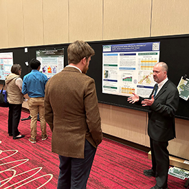 DRBC Manager of Water Quality Assessment John Yagecic, P.E., talks with a Summit attendee about our examination of socio-economic factors affecting improved dissolved oxygen in the Delaware River Estuary. Photo by the DRBC.