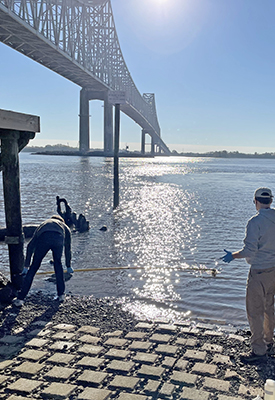 DRBC staff collects a surface water sample from the Delaware River to monitor for PFAS. Photo by DRBC.