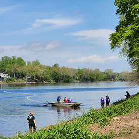 The Lewis Fishery Crew demonstrateshow they fish for shad using arowboat and large nets. Photo by the DRBC.