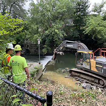 The bulldozer starts by breaking up the concrete top of the dam. The excavation work was done by Flyway Excavating. Photo by the DRBC.