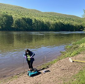 DRBC staff prepare to collect a water quality sample from the Delaware River at Smithfield Beach. Photo by DRBC.