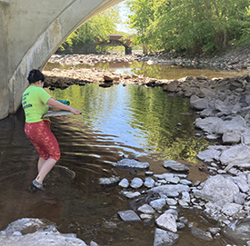 DRBC staff carry a continuous logger set-up to where it is going to be placed in the creek. Photo by DRBC.