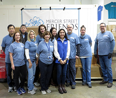 DRBC staff takes a group photo after packing over 1,400 meals for MSF's Send Hunger Packing Program. Photo by DRBC.
