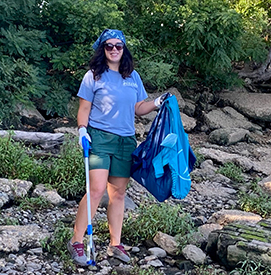 DRBC Water Resource Scientist Elaine Panuccio pauses from cleaning up the upper shoreline for a pic. Photo by the DRBC.