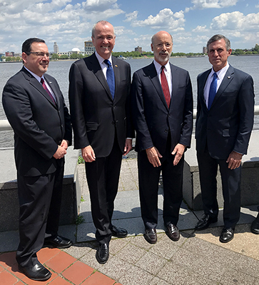 (From L to R) DRBC Executive Director Steve Tambini, N.J. Governor Phil Murphy, Pa. Governor Tom Wolf, and Del. Governor John Carney pose on the deck of Philadelphia's Independence Seaport Museum on the Delaware River. Photo by DRBC.