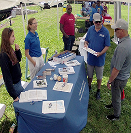 Trenton Mayor Reed Gusciora (grayshirt) stopped by the DRBC table fora chat. Photo by the DRBC.