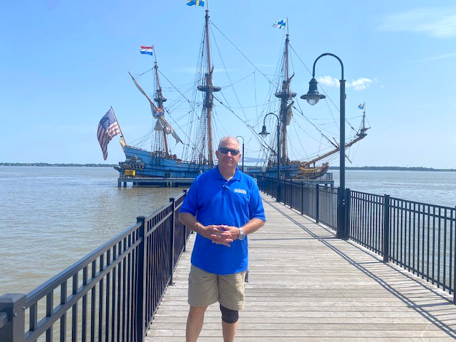 DRBC's Peter Eschbach poses in front of the Kalmar Nyckel docked in Newcastle, Del. Photo by DRBC.