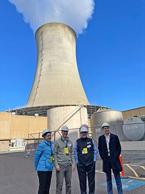 DRBC staff pose for a photo with one of Limerick's cooling towers in the background. Photo courtesy of Constellation Energy.
