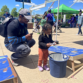 A father & son enjoy our macrosfishing game! Photo by the DRBC.