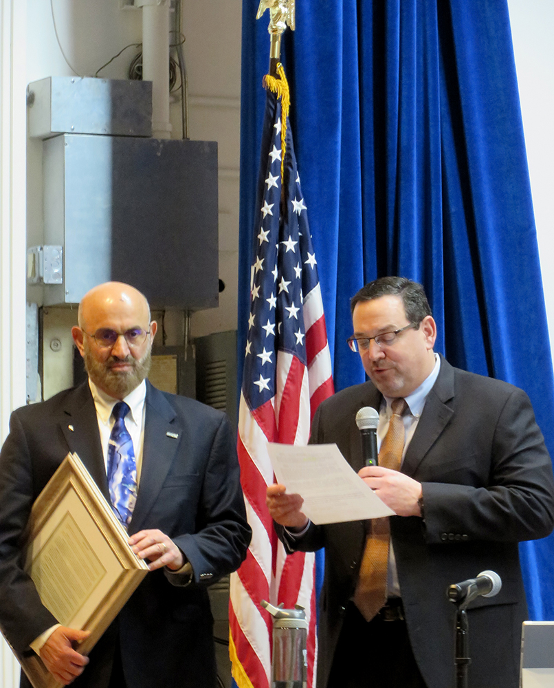 Dr. Ken Najjar (left) listens as DRBC Executive Director Steve Tambini reads the special resolution. Photo by DRBC.