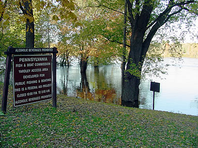 View of the submerged parking lot and boat ramp along River Road (Route 32) in Yardley, Pa. (3:55 p.m. on Oct. 30, 2003). At 4:15 p.m., the Delaware River was flowing at 81,600 cubic feet per second (cfs) as recorded by the USGS stream gage in nearby Trenton and the gage height was 16.56 feet. Although the National Weather Service flood stage for this gage is 20 feet, minor flooding begins along low stretches of River Road in Yardley beginning at 17 feet.