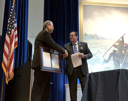 DRBC Communications Manager Clarke Rupert (L) shakes hands with DRBC Exec. Dir. Steve Tambini after STeve read the special resolution honoring Clarke's dedicated service to DRBC. Photo by DRBC.