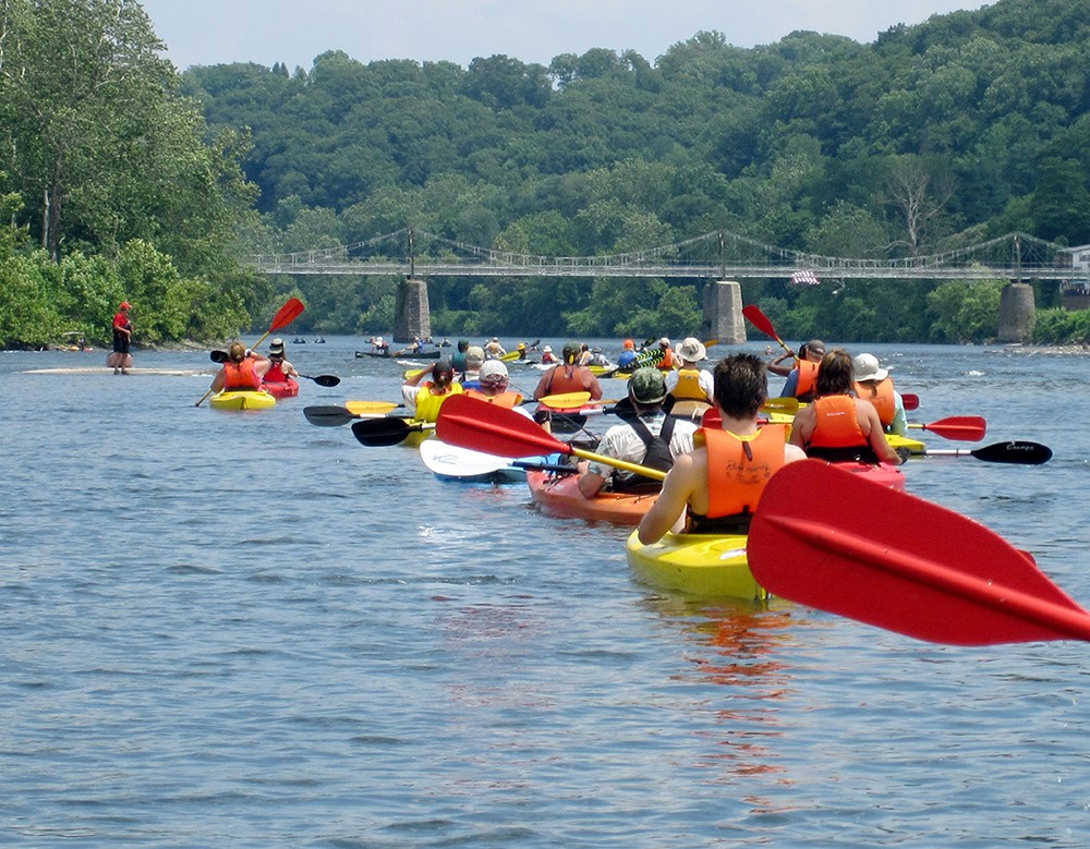 Sojourners line up to paddle through the Lumberville Wing Dam. Photo by the Delaware River Sojourn.