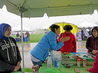 DRBC's Kate Schmidt explains how pollutants on the land can get into our rivers and streams when it rains. Photo by DRBC.