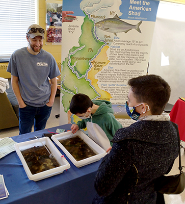 DRBC Aquatic Biologist Jake Bransky talks to EarthFest attendees about why we study aquatic insects. Photo by the DRBC.