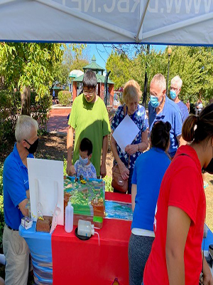 SPLASH's Eric Clark (left) uses the Enviroscape watershed model to show attendees what happens on land affects the water. Photo by DRBC.