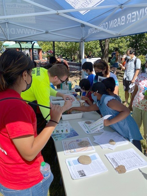 DRBC's Kyle McAllister (yellow shirt) explains what bugs we found. Mel (red shirt), is a local educator who helped us communicate with attendees who only spoke Spanish. Photo by DRBC.