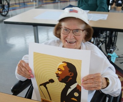 Veteran holding a print of a MLK poster