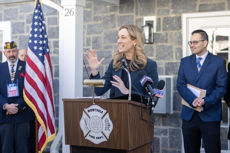 Governor Mikie Sherrill speaking to the crowd at the Montvale Ribbon Cutting with Michael Boll representing the NJ State Veterans of Foreign Wars (left), and AJ Luna (right) from NJ SOS Veterans.