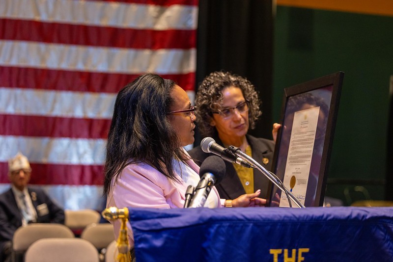Esther Chucaralao, Deputy Commissioner of Veterans Affairs, and Lucy DelGaudio, Women Veterans Coordinator, Division of Veterans Services, presenting a proclamation designating June 12, 2026, as Women Veterans Day.