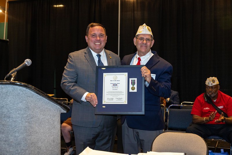 Commissioner Vincent Solomeno presenting Department Commander Robert Buccino with the New Jersey Commendation Medal.