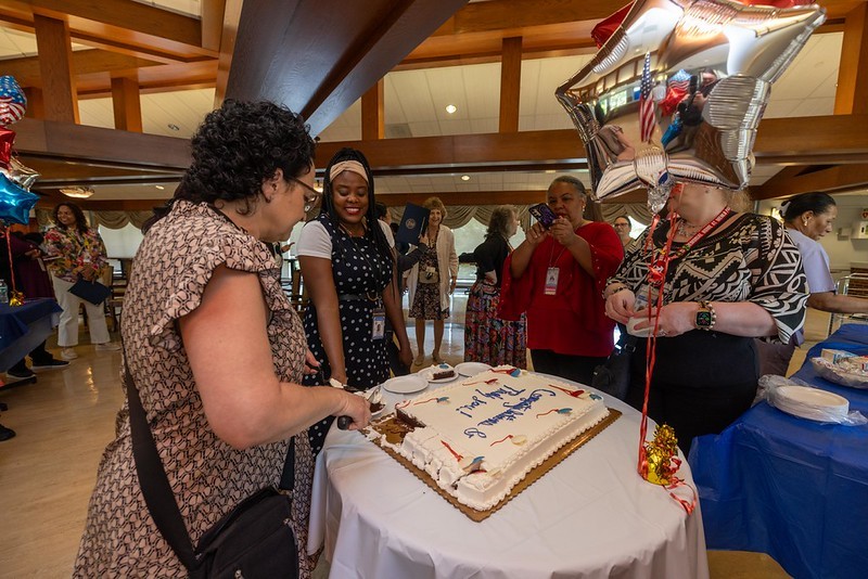 Group of Melo Park team members cutting the cake at the event.