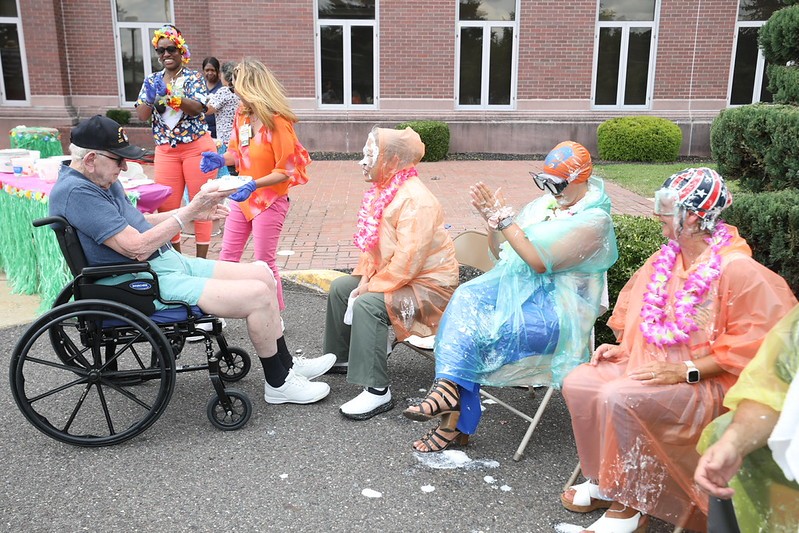 Vineland resident participates in pie-throwing contest at the home's end-of-summer luau.