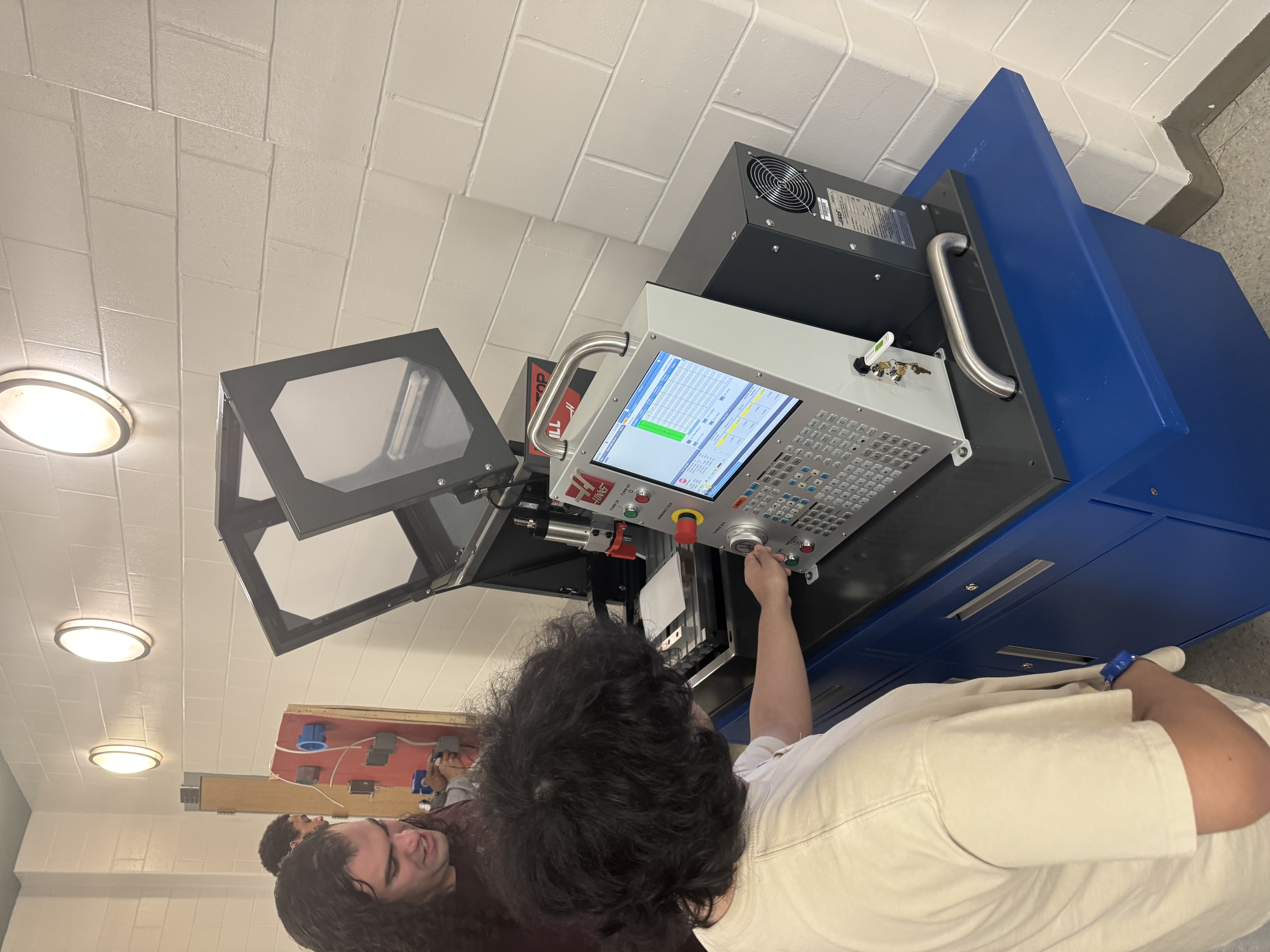 Teacher and student with CNC machine