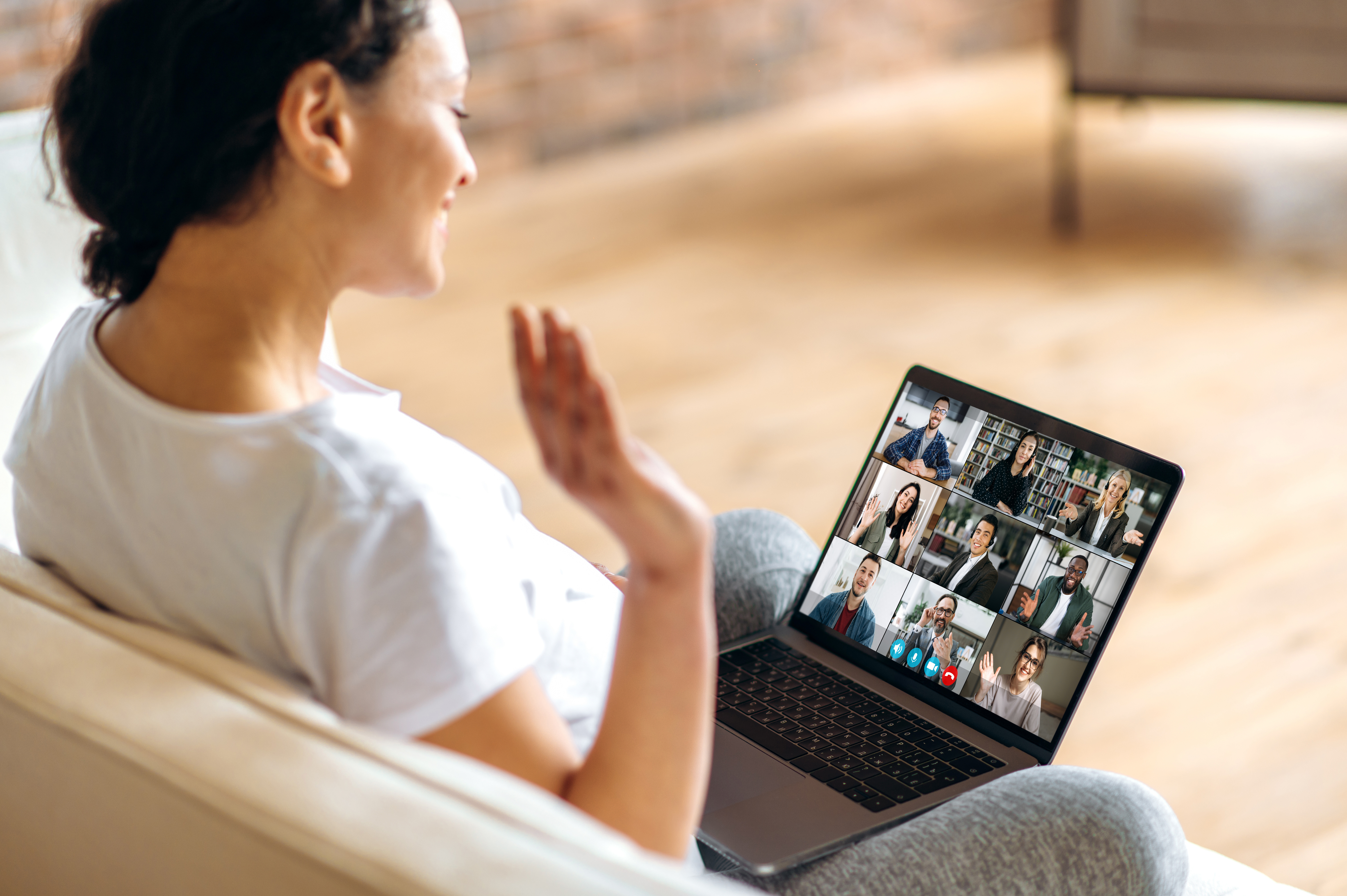 A parent waving during a virtual parent group meeting